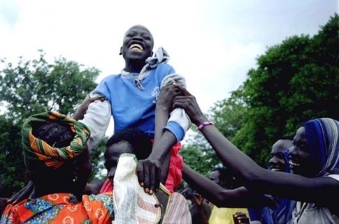 A jubilant 12-year-old boy rejoices after seeing his family for the first time in three years in southern Sudan